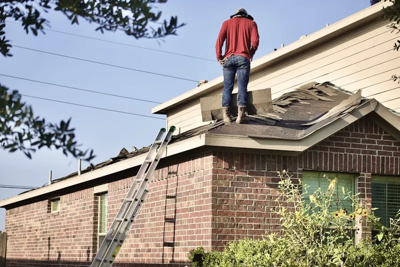 Professional roofer working on a residential roof in Terrell Hills